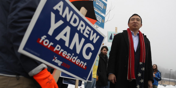 FEBRUARY 11: Democratic presidential candidate Andrew Yang greets supporters in who are holding signs in front of a polling station on February 11, 2020 in Keene, New Hampshire. New Hampshire holds its first in the nation primary today.