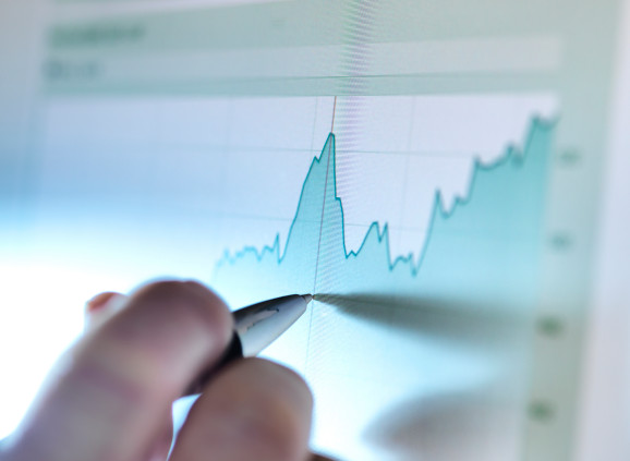 a person marks, with a pen, a local maximum on an on-screen graph
