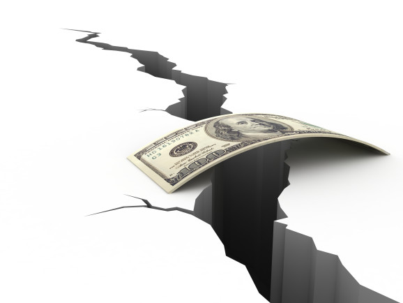A 100 dollar bill forms a bridge over a chasm