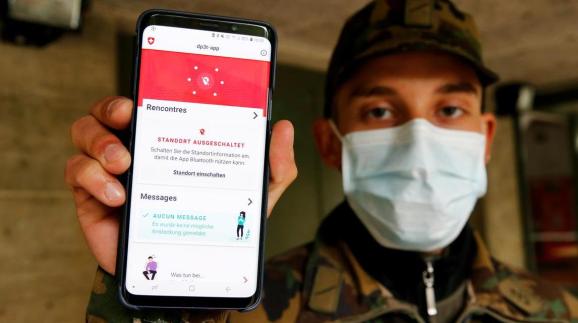 FILE PHOTO: A Swiss soldier shows on a mobile device the contact tracking application created by the Swiss Federal Institute of Technology Lausanne (EPFL)