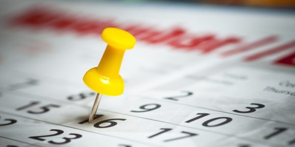 Calendar date marked by a push pin