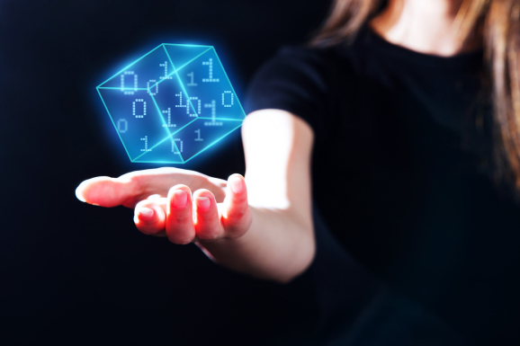 Woman's hand showing a digital cubic with a pixel binary numbers data.