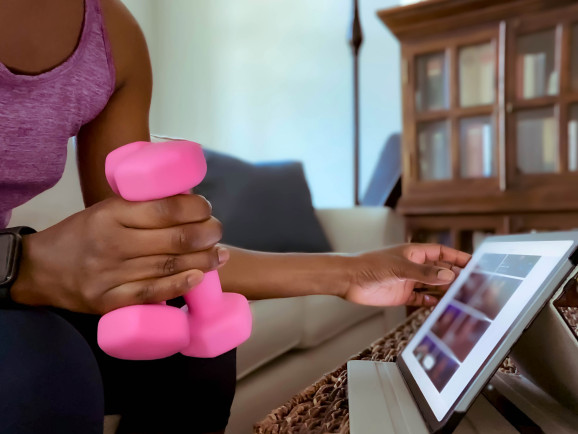 Woman Searches Mobile App on Digital Tablet for Exercise Class