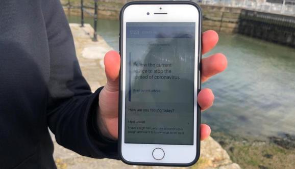 UK National Health Service employee Anni Adams shows a smartphone displaying the new NHS app to trace contacts with people potentially infected with the coronavirus disease (COVID-19) being trialled on Isle of Wight, Britain, May 5, 2020