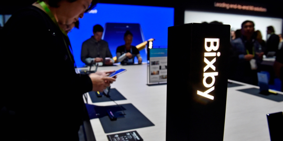 LAS VEGAS, NEVADA - JANUARY 8: Attendees examine Bixby-enabled devices at the Samsung booth during CES 2019 at the Las Vegas Convention Center on January 8, 2019