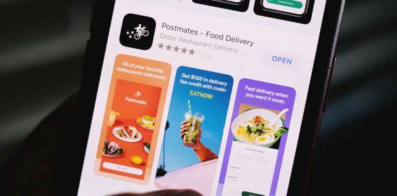 Illustration photo taken on June 30, 2020 shows the logo of delivery app Postmates on a smartphone screen in Los Angeles.
