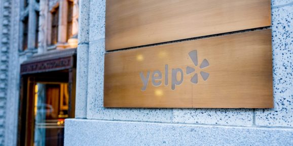 Sign on facade at headquarters of travel and restaurant rating company Yelp in San Francisco, California, December 25, 2018.