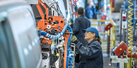 Female worker on vehicle production line in car factory