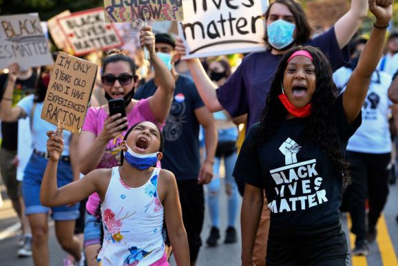 Garden City, N.Y.: Cristiana Gant, 9, of Rockville Centre, New York, left, shouts alongside fellow activists during a protest in Garden City against police brutality in the wake of the Death of George Floyd, on June 23, 2020.