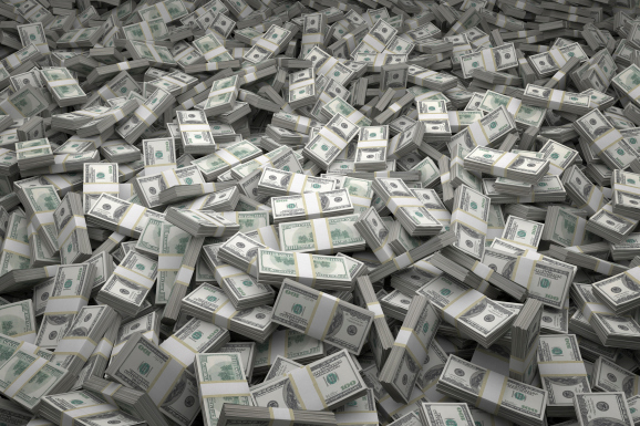 Bundles of $100 US dollar bills scattered randomly. Billions of dollars worth of money spread over the ground and viewed from above. A sea of money and great background.