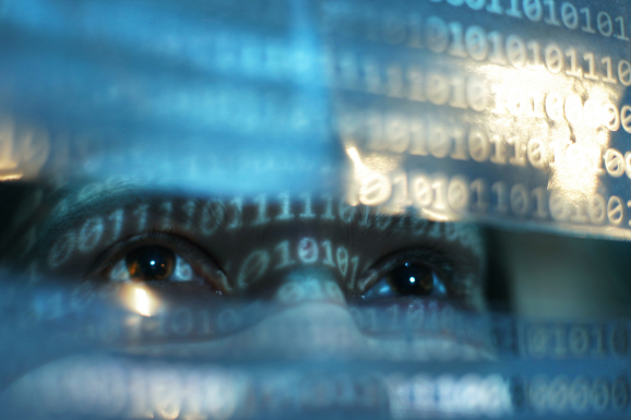 Closeup view of womans face lit by binary code