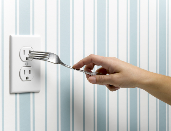 Someone sticking a fork into an electrical socket
